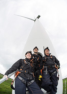 Employees in front of wind turbine