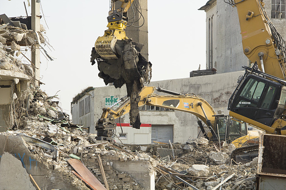 Bagger reißen Gebäude ab