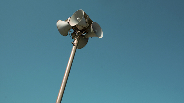 Megaphones in front of a sky